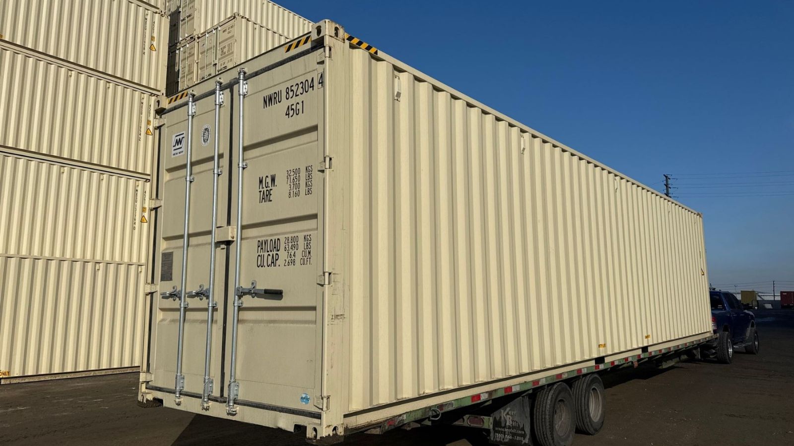 new one-trip 40ft High Cube shipping container on a trailer at a Kansas City area depot